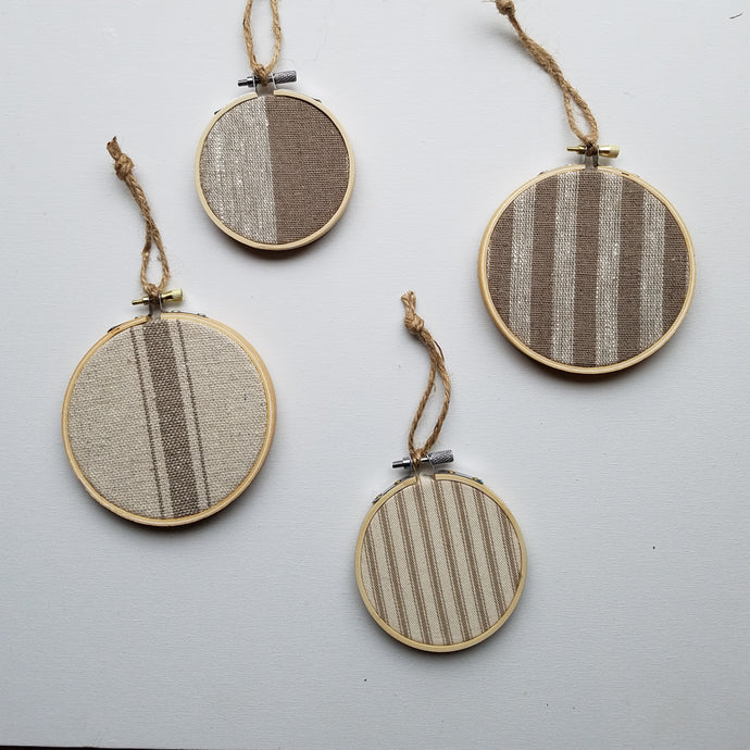 FourFarmhouse Feedsack Christmas Ornaments, Taupe and Natural on a grey background