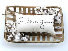 customizable handwriting pillow sitting inside a woven basket, decorated with cotton