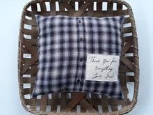 Memory Pillow Made from Loved Ones Shirt with Their Handwriting sitting inside a woven basket