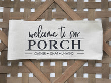 Welcome to our Porch Faux Burlap Off-White Pillow Wrap, laying in a woven basket