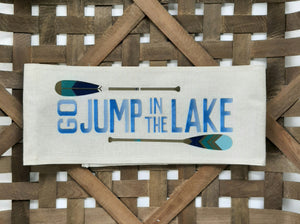 Go jump in the lake faux burlap off - white pillow wrap sitting in a woven basket