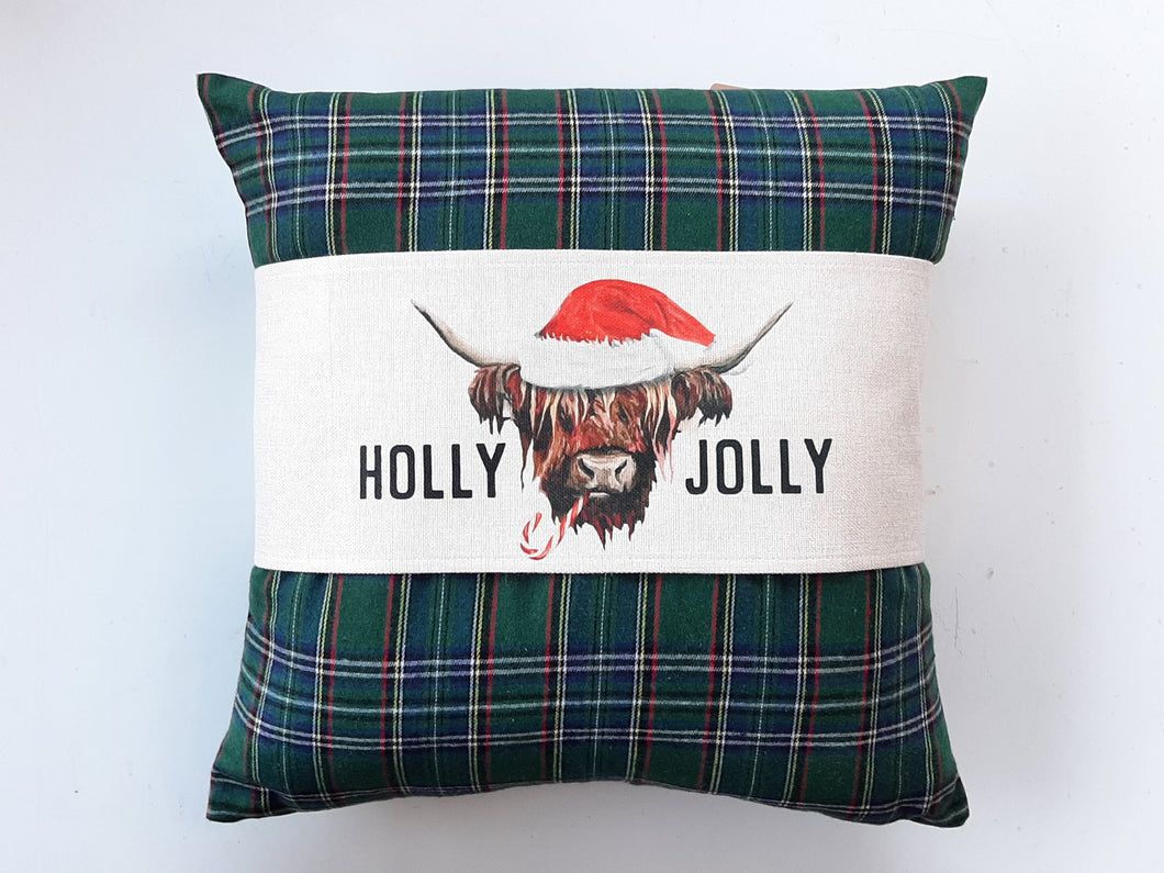 Holly Jolly Highland Cow Pillow Wrap, wrapping around a green and red patterned pillow   