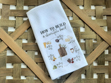 Kitchen towel that explains how to build a charcuterie board