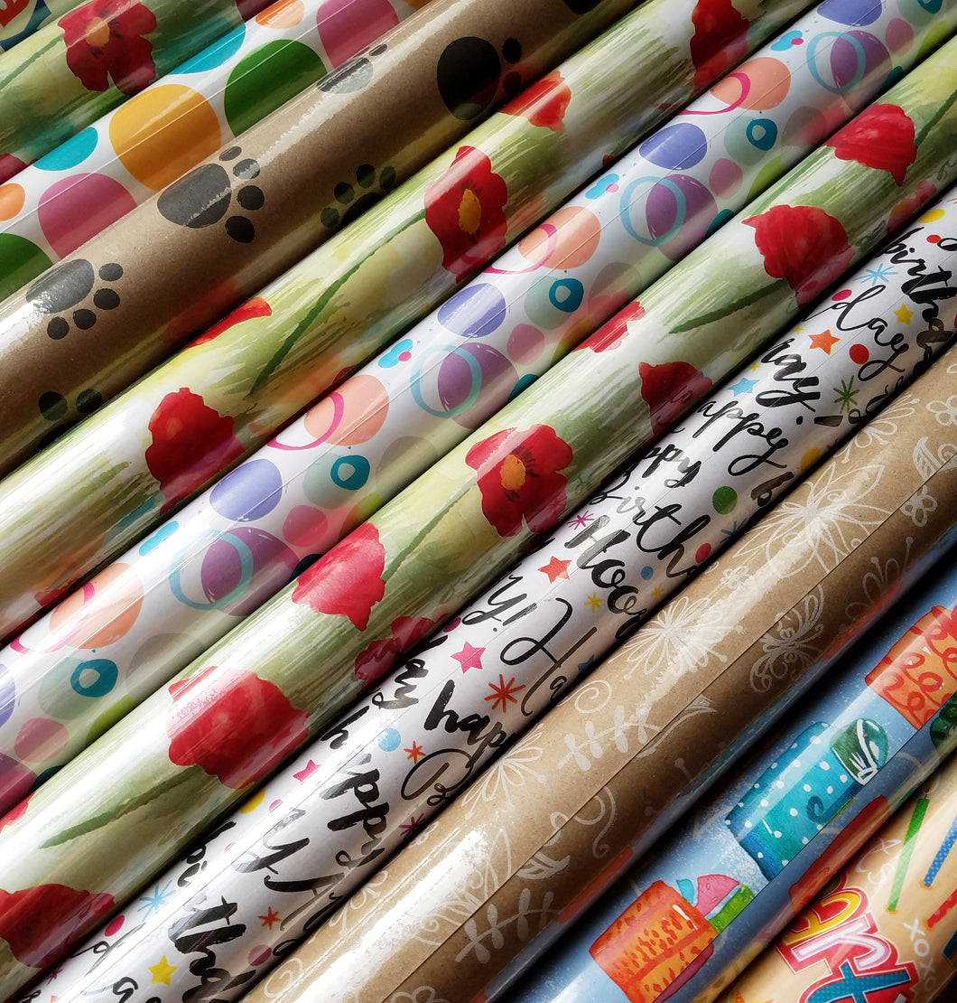 several gift wrapping tubes of different colors and prints 