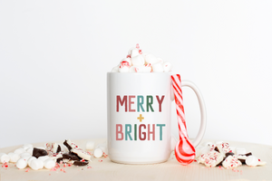 Merry and Bright Christmas Mug filled with marshmallows and surrounded by chocolate, a candy cane and more marshmallows
