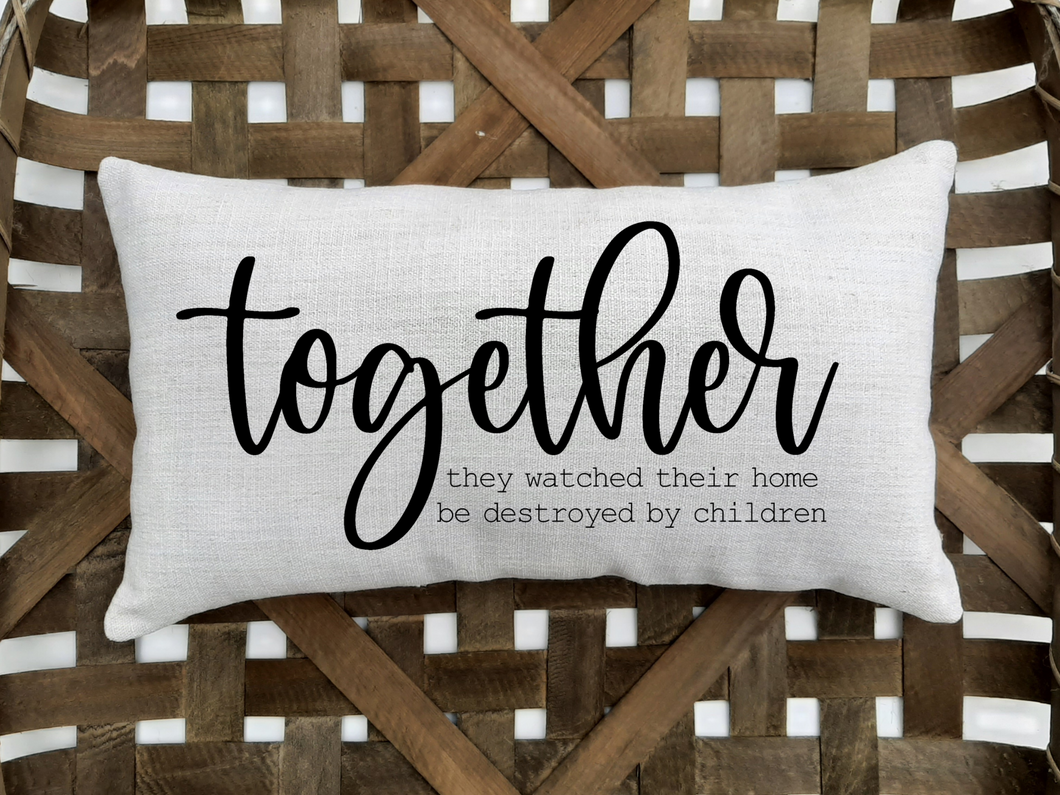 Together They Watched Their Home Be Destroyed By Children Decorative Pillow, sitting inside a woven basket