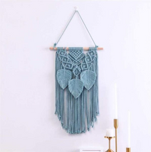 blue Macrame Wall Hanging on a white wall 