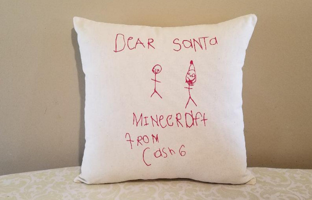 customizable kid's drawing or artwork pillow leaning against a tan wall