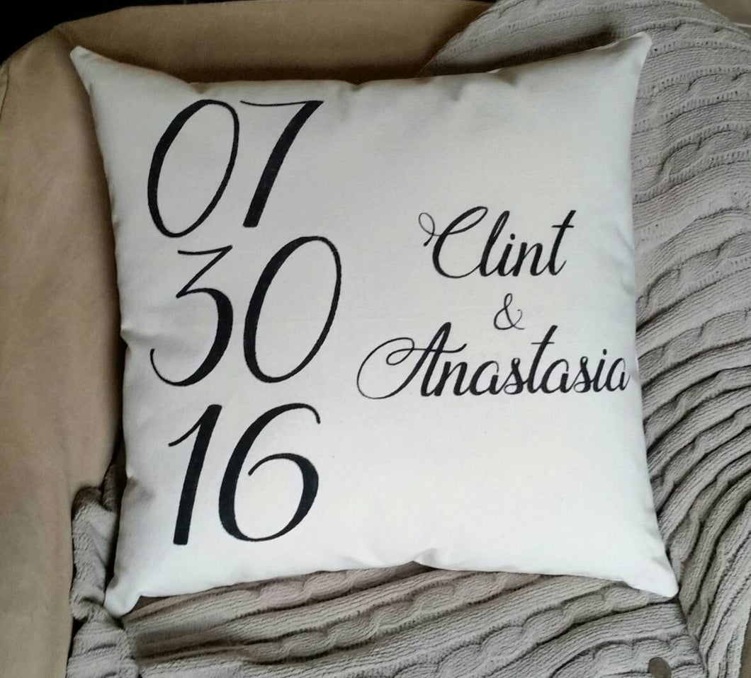 Personalized Wedding Date Accent Pillow sitting on a chair with a blanket