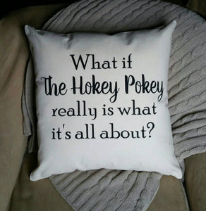 canvas pillow that reads what if the hokey pokey really is what it's all about? sitting on a cozy chair