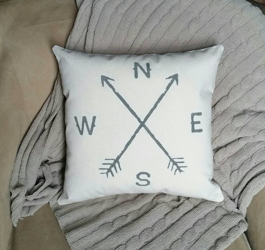 Rustic Arrow Compass Accent Pillow, sitting on a couch with a grey blanket