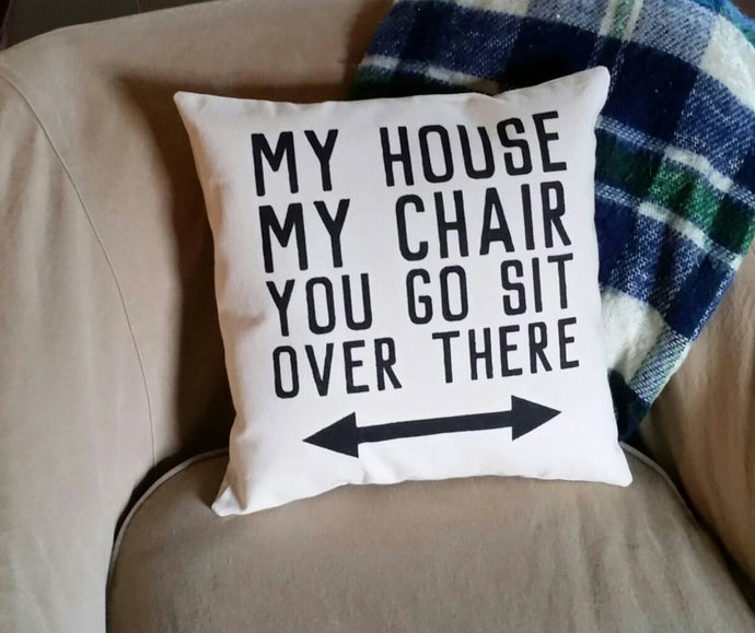 My House, My Chair, You Go Sit Over There Pillow with arrows, sitting on a chair with a blanket