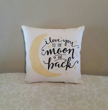 I love you to the moon and back pillow | New Baby Shower Gift, leaning against a tan wall