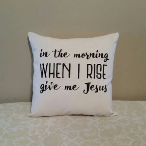 In the morning when I rise, give me Jesus Pillow leaning against a tan wall