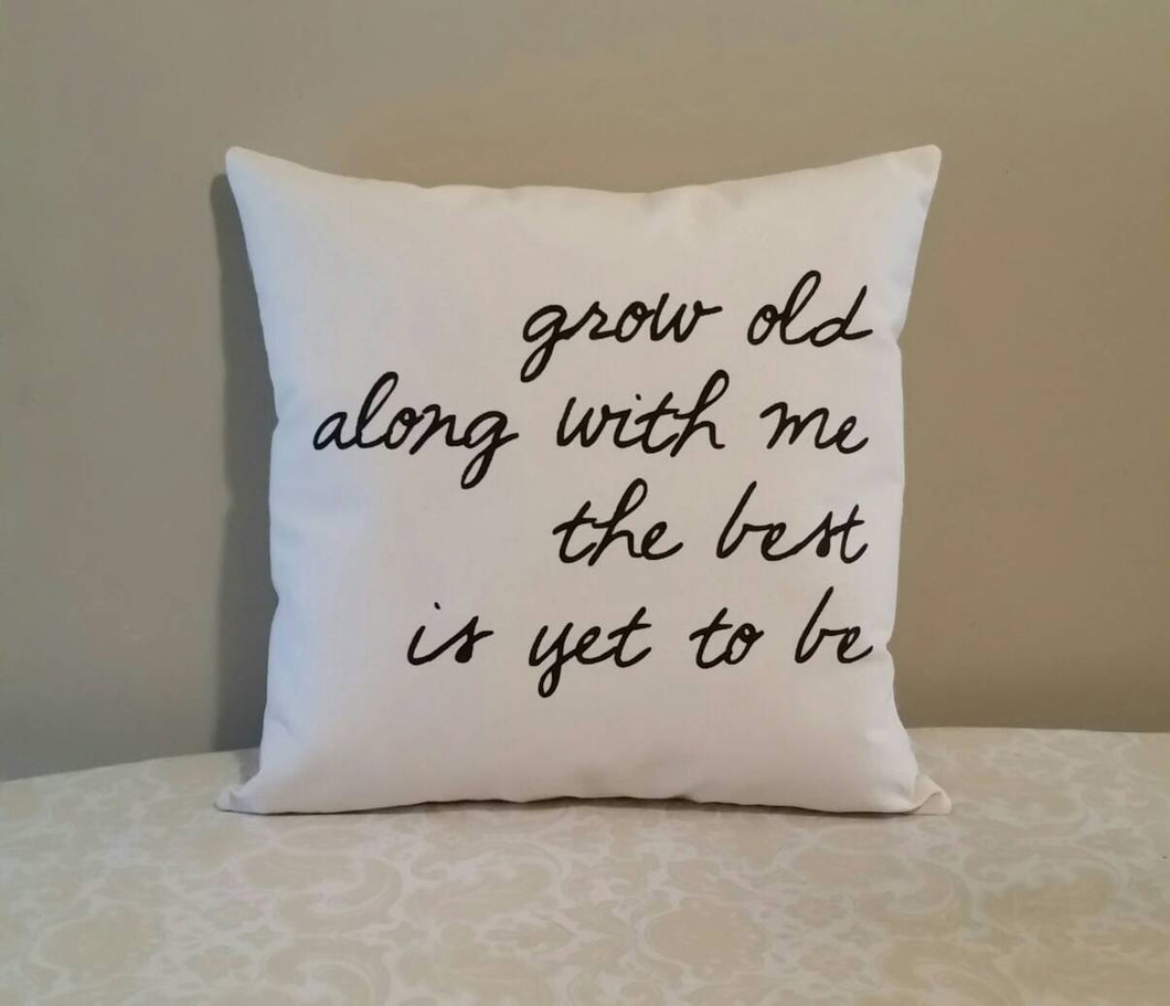 Grow Old Along with Me The Best is Yet to Be Accent Pillow, leaning against a tan wall