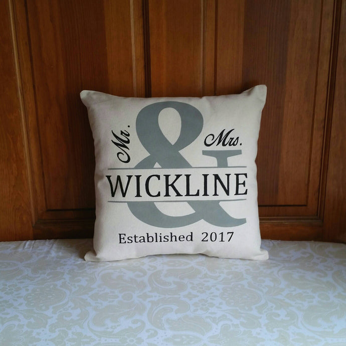 personalized Mr and Mrs wedding pillow, leaning against a wooden door