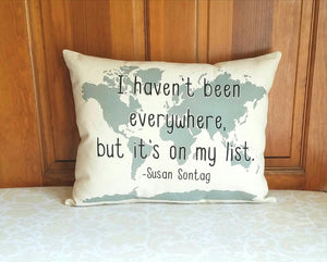 I haven't been everywhere, but it's on my list map pillow leaning against a wooden door