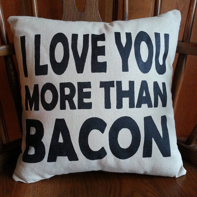 I Love You More Than Bacon Throw Pillow sitting in a wooden chair