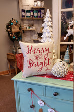 Merry & Bright Decorative Christmas Pillow on display in a shop