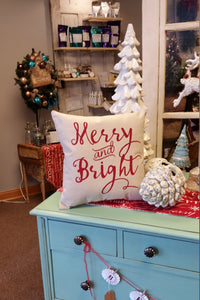 Merry & Bright Decorative Christmas Pillow on display in a shop