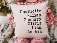 girl in Christmas pajamas holding a customizable list of favorites pillow