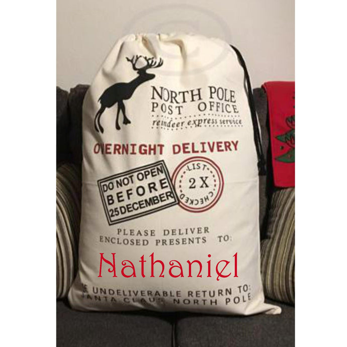 Personalized Christmas Santa Bag sitting on a couch