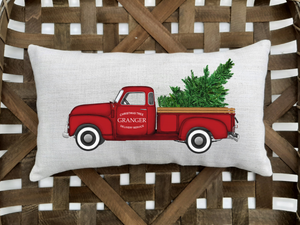 custom family name Christmas tree delivery service pillow against a woven basket background